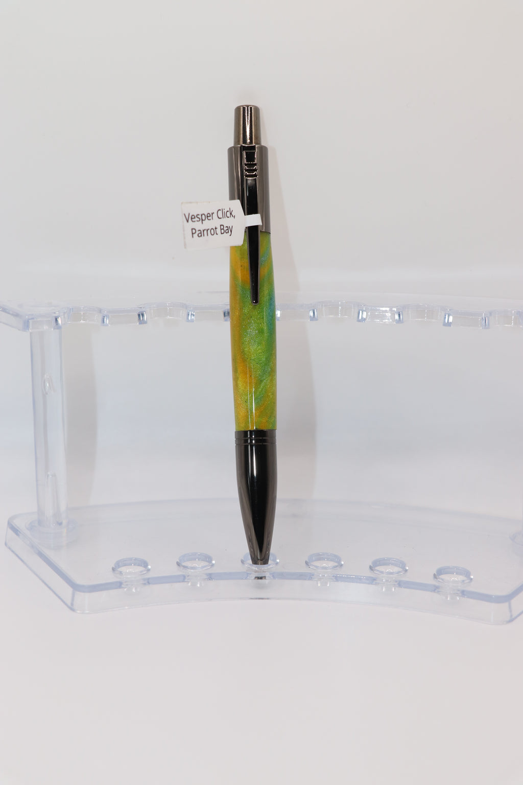 Parrot Bay Acrylic:  Pen with yellow and Gun Metal design on a clear stand against a white background