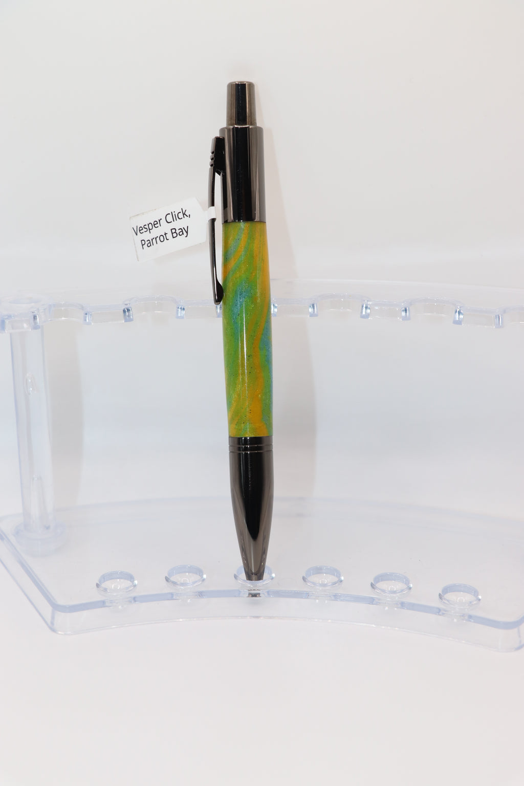 Parrot Bay Acrylic:  Pen with yellow and Gun Metal design on a clear stand against a white background