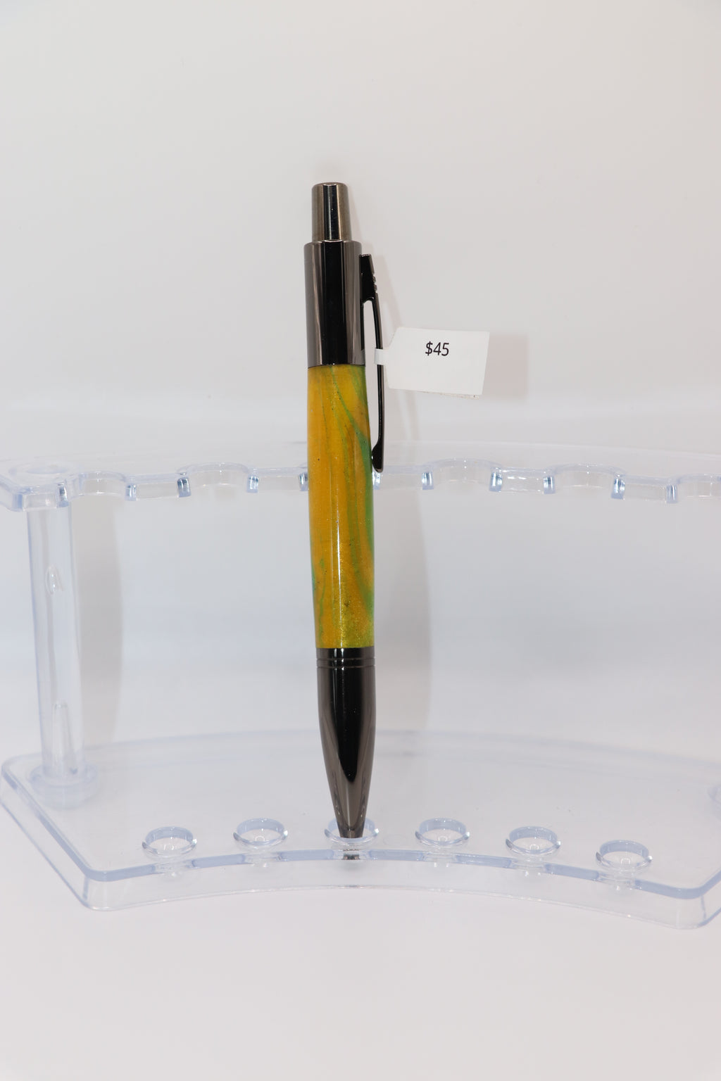 Parrot Bay Acrylic:  Pen with yellow and Gun Metal design on a clear stand against a white background