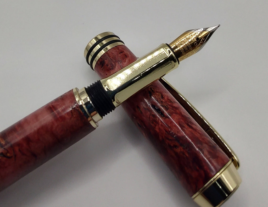 Tycoon fountain pen in red maple burl with gold and black trim